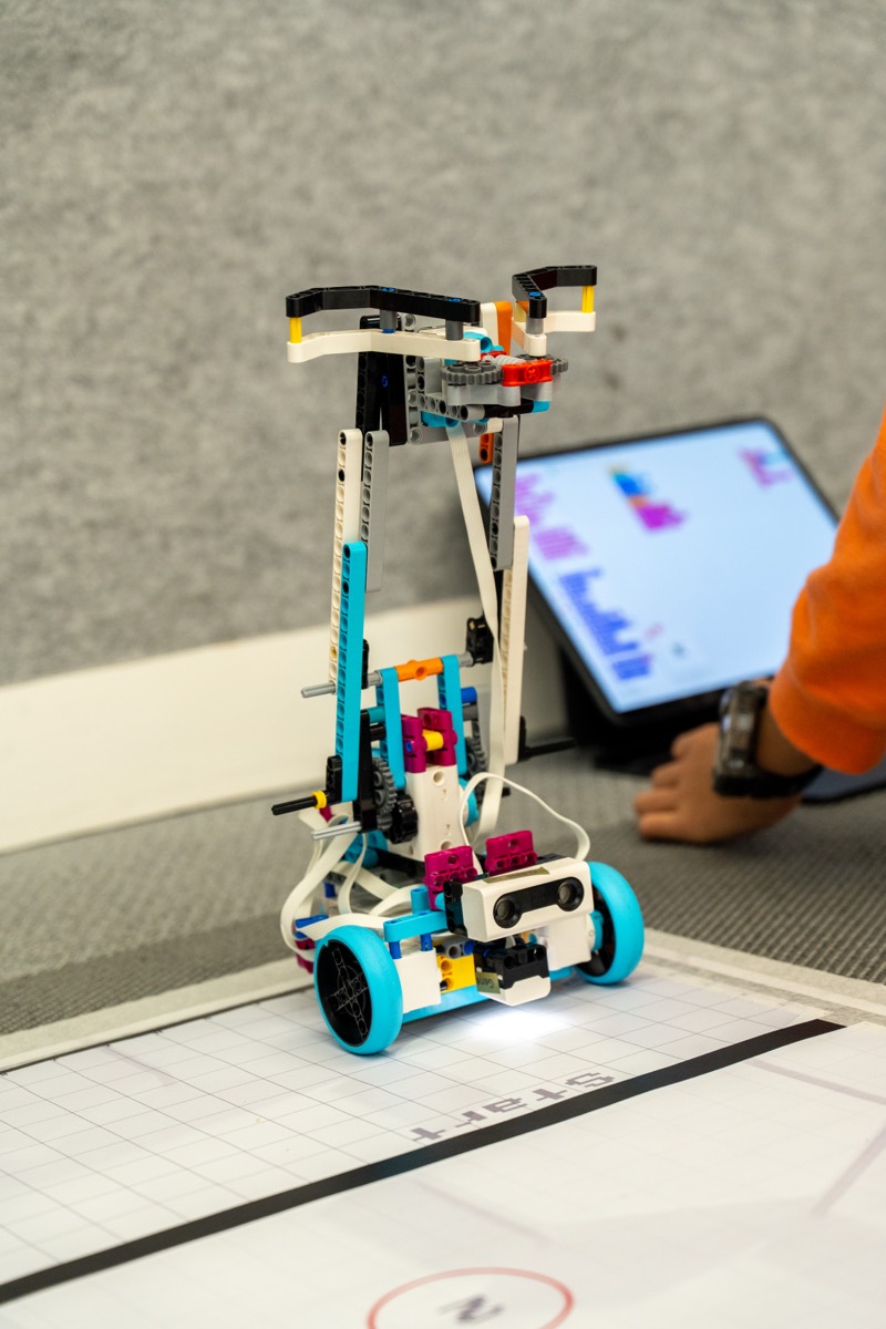 A student-built LEGO SPIKE robot on the official JBC game mat — any kit is welcome